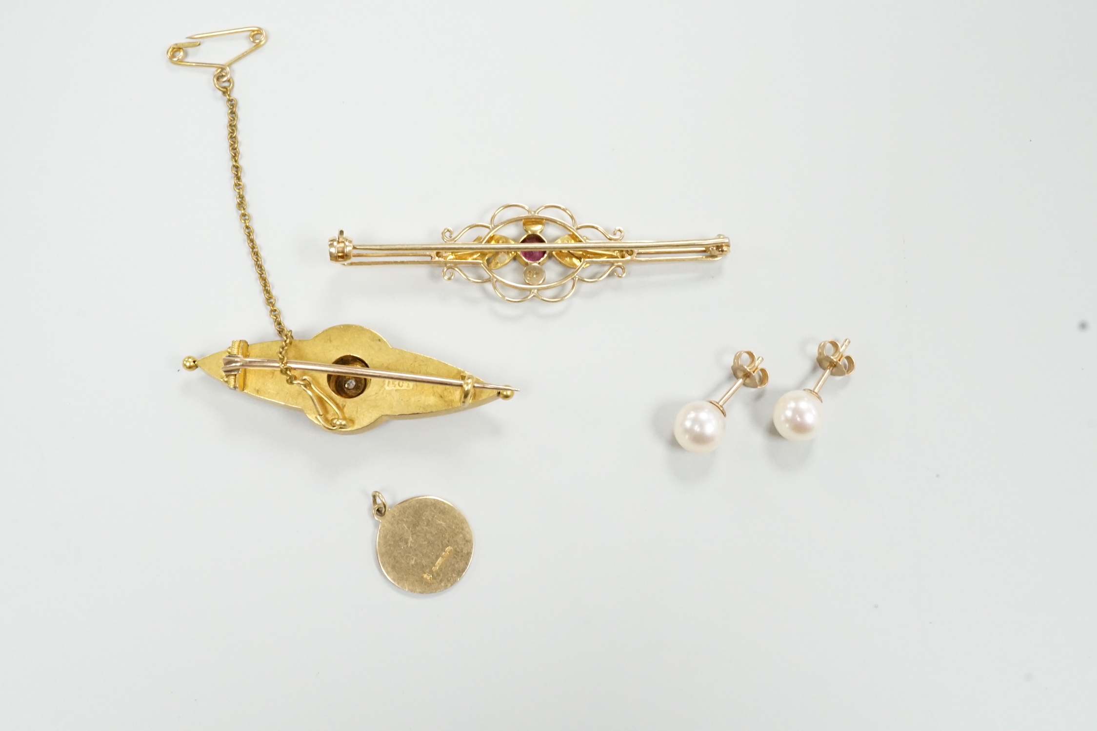 A Victorian 15ct and diamond set brooch, 45mm, a similar 9ct and gem set brooch, a pair of cultured pearl ear studs and a 9ct small medallion.